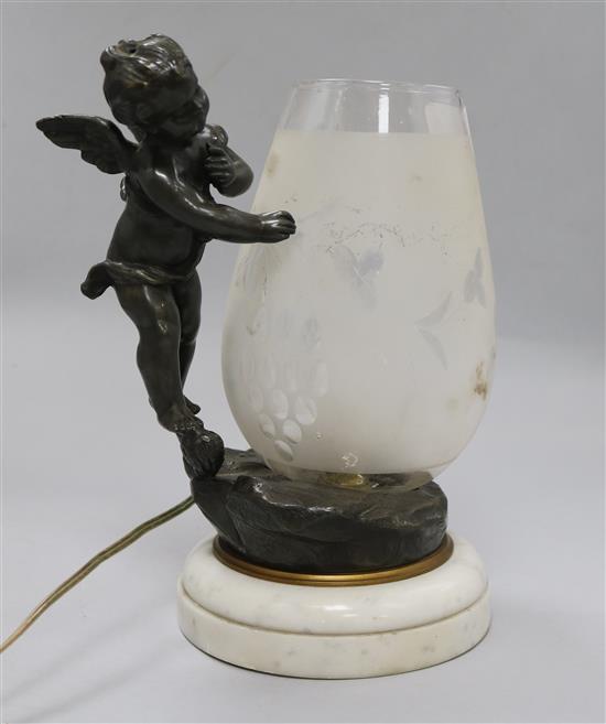 A cherub and glass table lamp